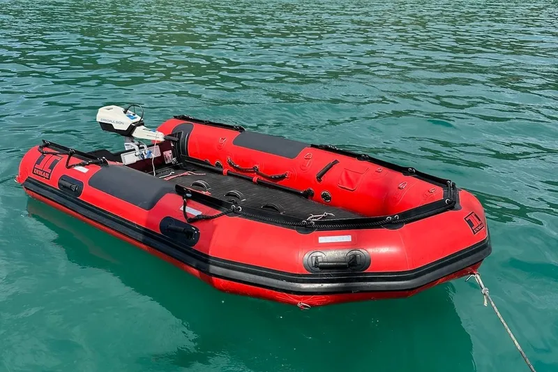 Slide: The Image of Red inflatable boat with motor on clear water, Hylas 56, 2012 model. - 48