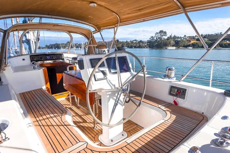 Slide: The Image of Luxurious 2012 Hylas 56 yacht cockpit with wooden deck and modern navigation equipment. - 9