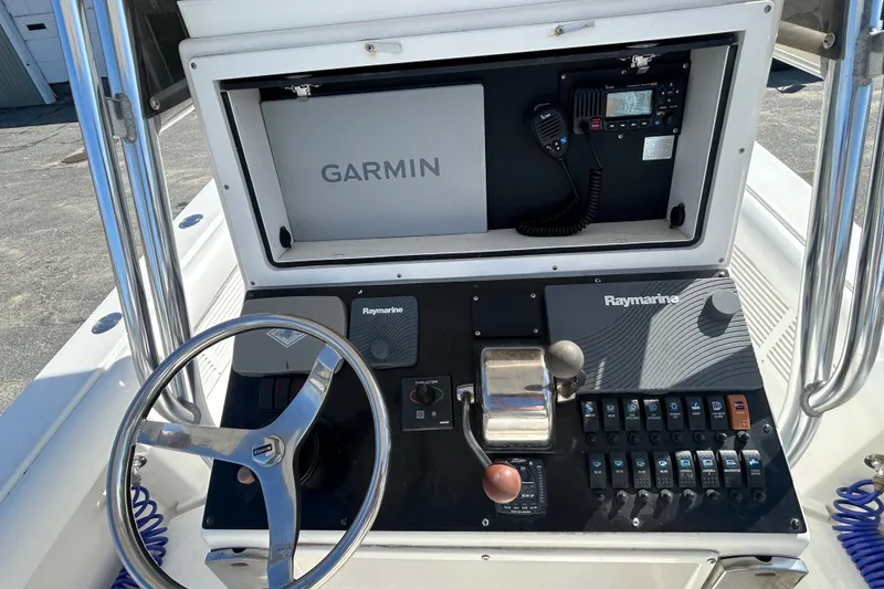 Slide: The Image of 2006 Albin 26 Center Console dashboard with Garmin and Raymarine electronics. - 15