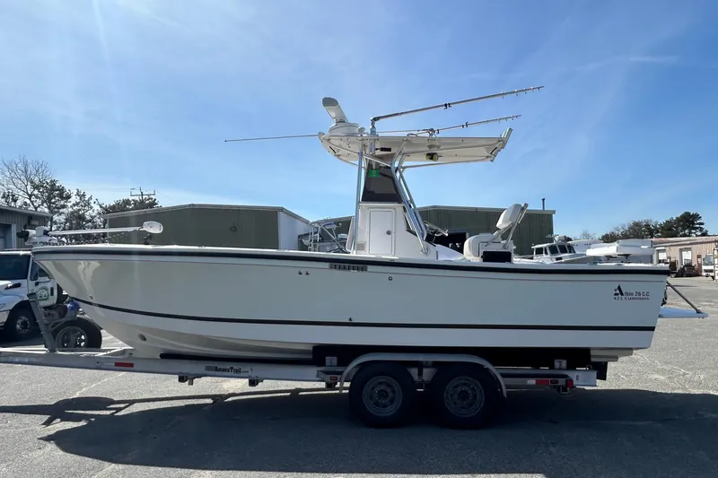 Slide: The Image of 2006 Albin 26 Center Console boat on trailer under clear blue sky. - 2