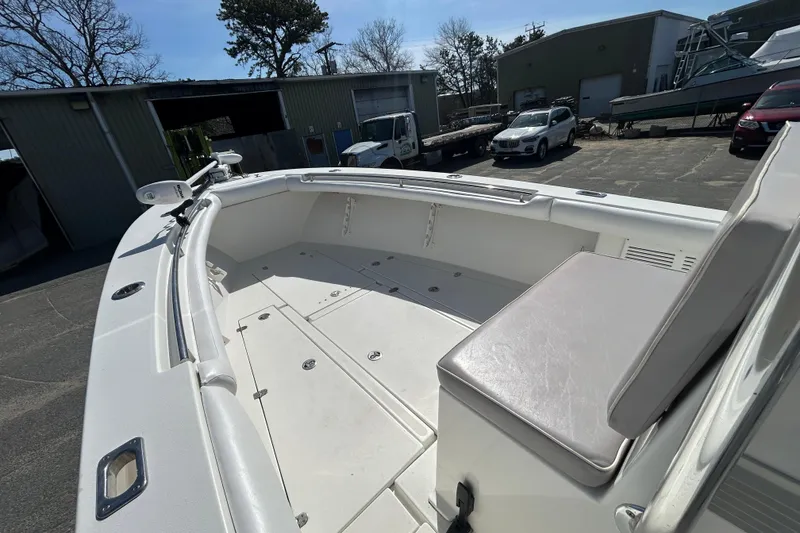 Slide: The Image of 2006 Albin 26 Center Console boat with spacious deck and seating in a marina setting. - 20
