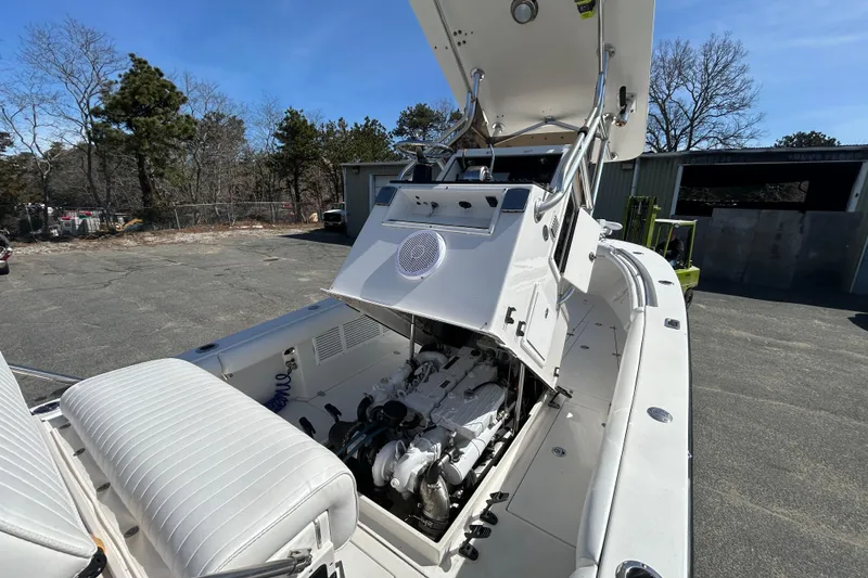 Slide: The Image of 2006 Albin 26 Center Console boat with open engine compartment, parked outdoors. - 37