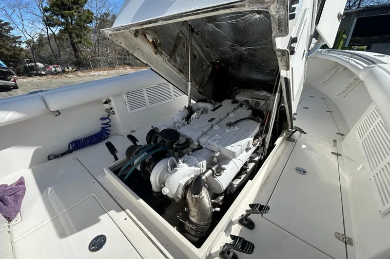 Slide: The Image of 2006 Albin 26 Center Console boat engine compartment with open hatch, showcasing the engine. - 39