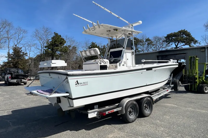 Slide: The Image of 2006 Albin 26 Center Console boat on trailer, parked outdoors under clear sky. - 5