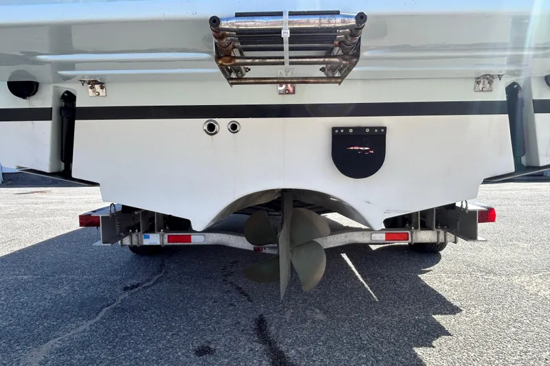 Slide: The Image of Rear view of a 2006 Albin 26 Center Console boat on a trailer, showing propeller and hull details. - 6