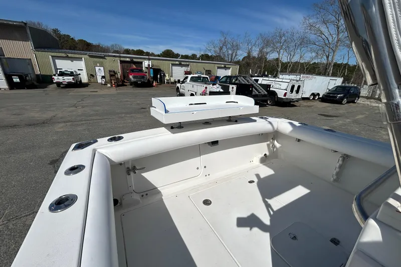 Slide: The Image of 2006 Albin 26 Center Console boat in a parking lot with vehicles and buildings. - 9