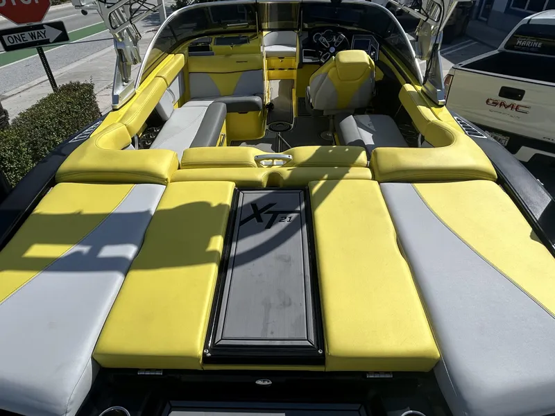 Slide: The Image of Interior of a 2021 MasterCraft XT21 boat with yellow and gray seating. - 3