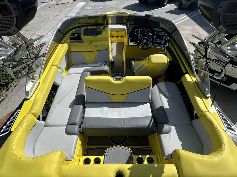 Slide: The Image of Interior of a 2021 MasterCraft XT21 boat with yellow and gray seating. - 5