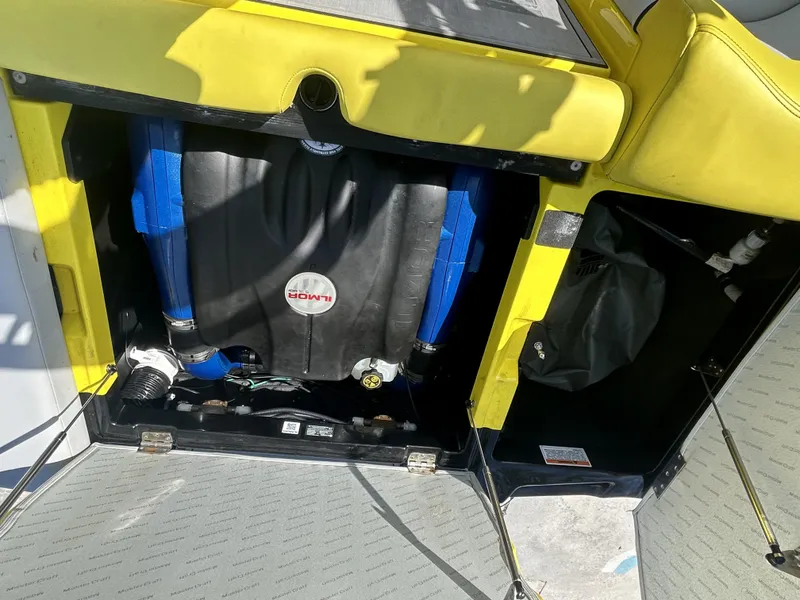 Slide: The Image of Engine compartment of a 2021 MasterCraft XT21 boat with yellow trim. - 6