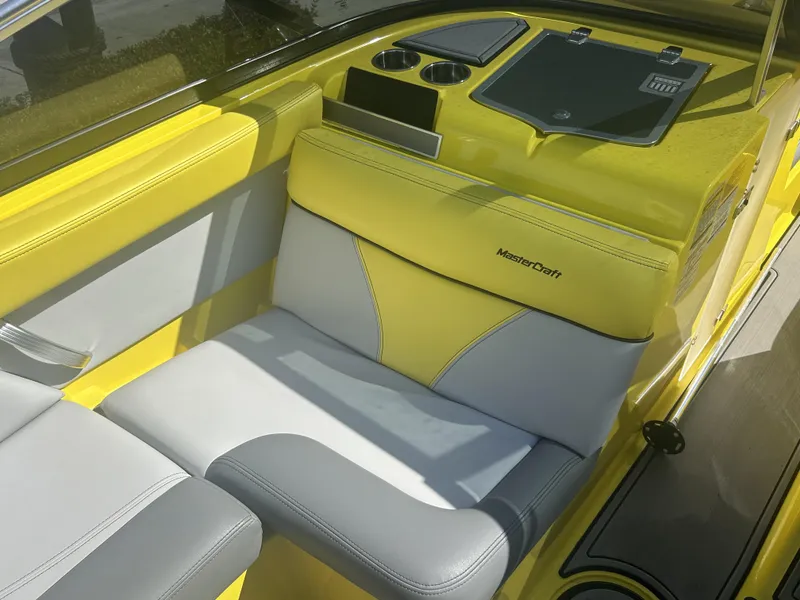 Slide: The Image of Interior of a yellow 2021 MasterCraft XT21 boat with gray and white seating. - 9