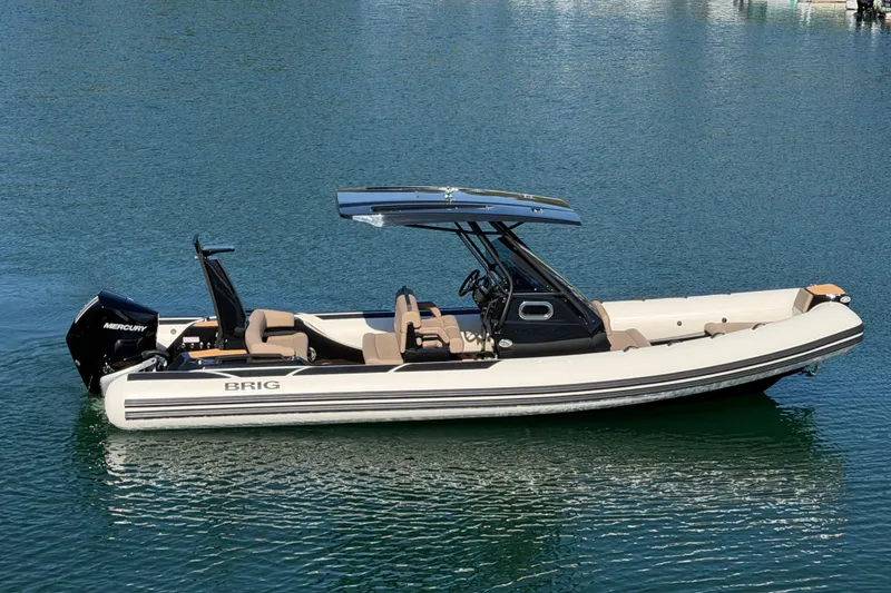 The Image of 2026 Brig Eagle 8 boat on calm water, featuring sleek design and Mercury engine. - 0