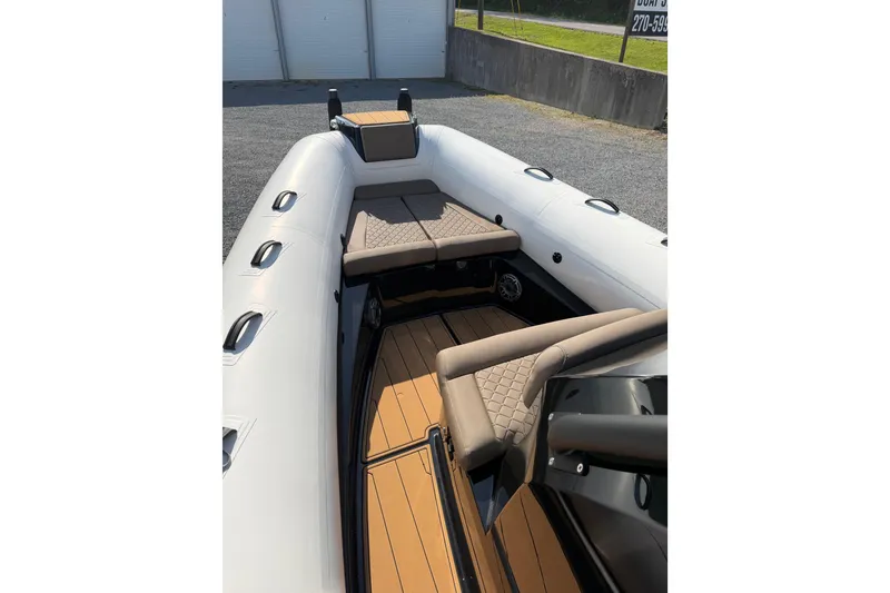 Slide: The Image of 2026 Brig Eagle 8 boat interior with cushioned seating and sleek design. - 10