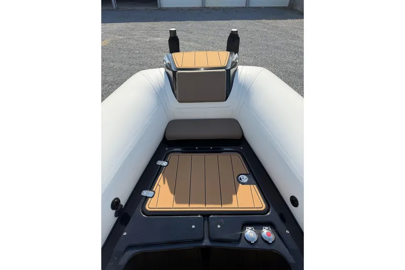 Slide: The Image of 2026 Brig Eagle 8 boat interior with cushioned seating and storage compartment. - 11