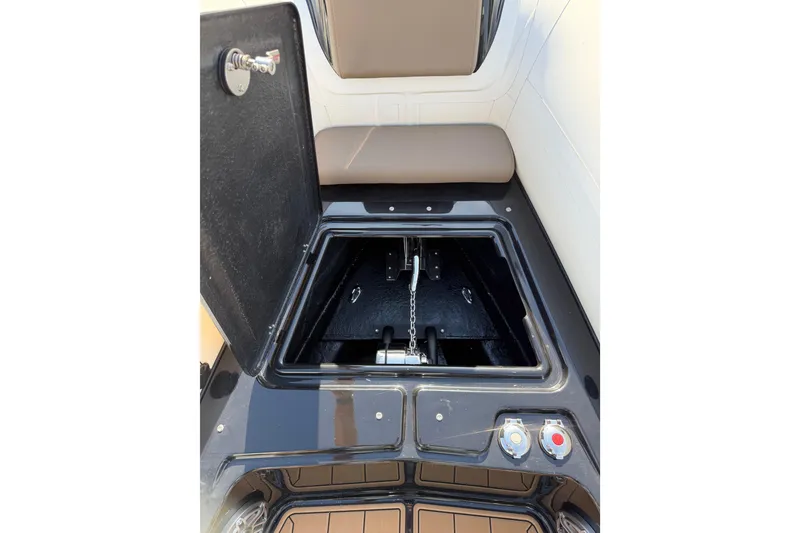 Slide: The Image of 2026 Brig Eagle 8 boat storage compartment with open hatch and visible chain mechanism. - 12