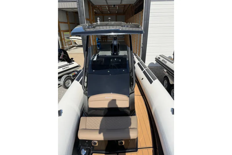 Slide: The Image of 2026 Brig Eagle 8 boat with sleek design and modern features in a storage area. - 13