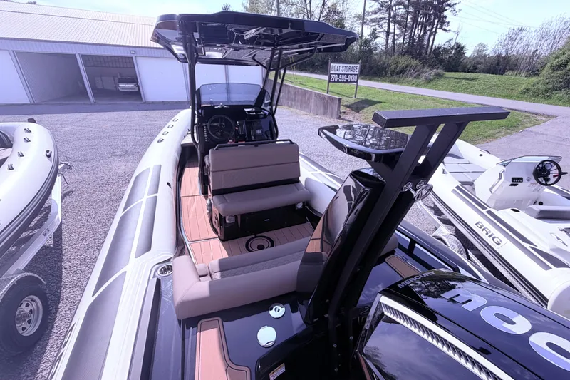Slide: The Image of 2026 Brig Eagle 8 boat with sleek interior and modern design, parked near storage facility. - 4