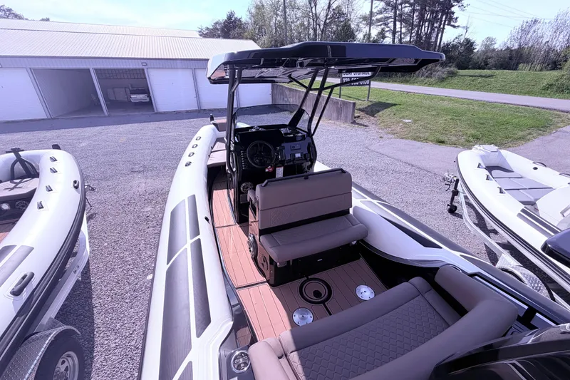 Slide: The Image of 2026 Brig Eagle 8 boat with sleek design and spacious seating, parked outdoors. - 6