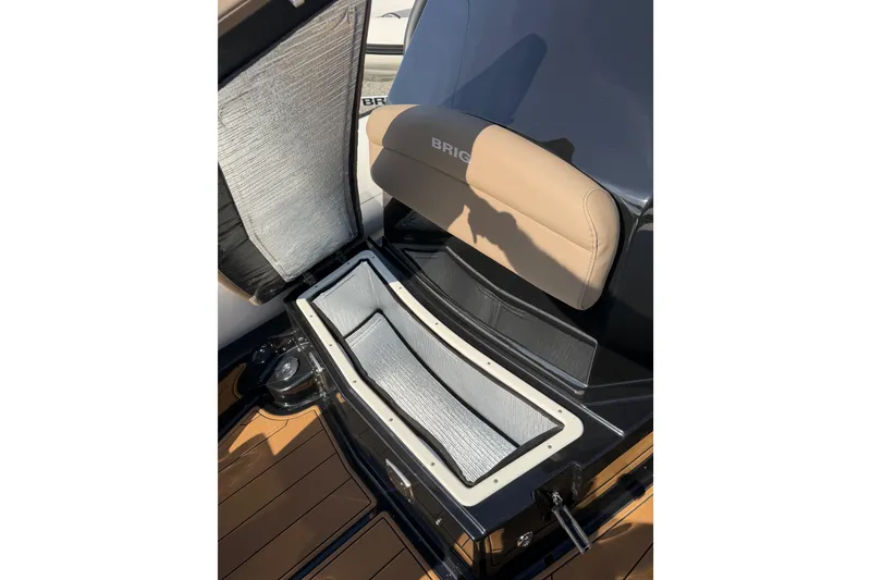 Slide: The Image of 2026 Brig Eagle 8 boat seat with storage compartment, featuring beige upholstery and sleek design. - 8