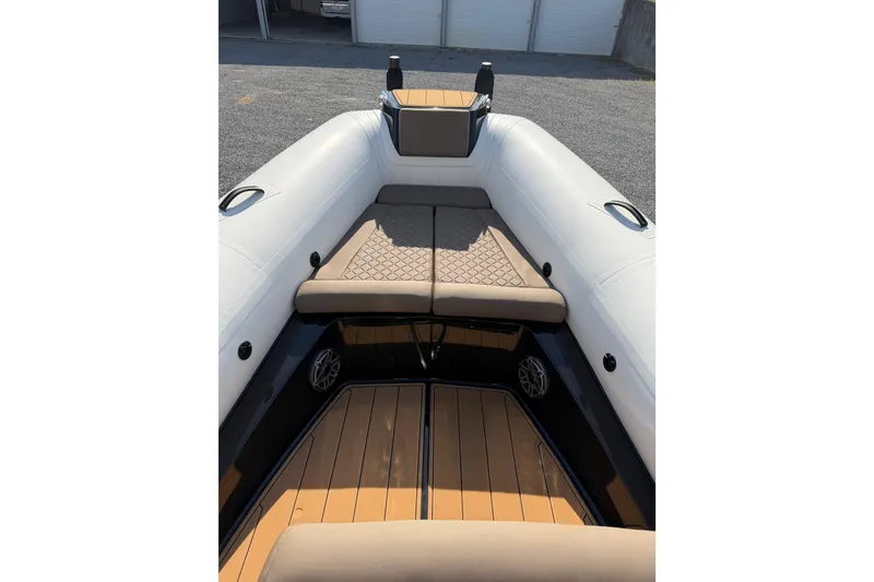 Slide: The Image of 2026 Brig Eagle 8 boat interior with cushioned seating and sleek design. - 9