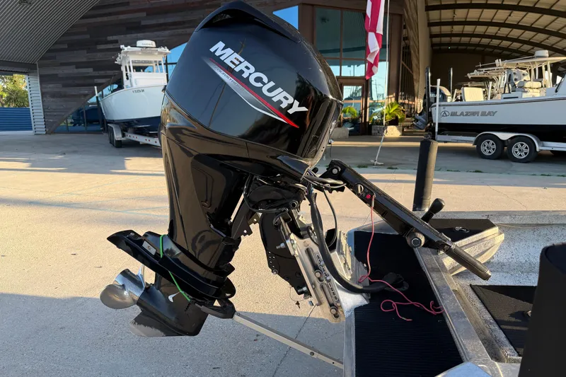 Slide: The Image of Outboard motor on a 2017 Homemade 1754 boat, parked near a marina. - 11