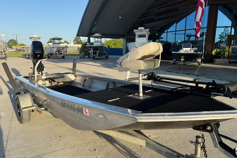 Slide: The Image of 2017 Homemade 1754 boat with motor and seating, parked outdoors near a building. - 4