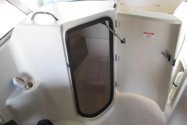 Slide: The Image of 2009 Grady-White Tournament 205 boat interior cabin with open door. - 13