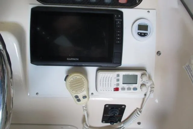 Slide: The Image of Control panel of a 2009 Grady-White Tournament 205 with Garmin GPS and communication devices. - 15