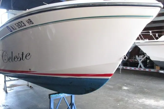 Slide: The Image of 2009 Grady-White Tournament 205 boat in storage, featuring a sleek white hull. - 18