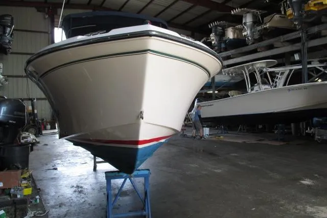 Slide: The Image of 2009 Grady-White Tournament 205 boat in storage, viewed from the front in a warehouse. - 20