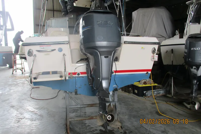 Slide: The Image of 2009 Grady-White Tournament 205 boat in storage, featuring Yamaha outboard motor. - 22