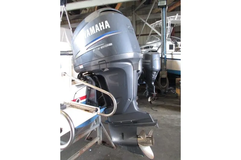 Slide: The Image of 2009 Grady-White Tournament 205 with Yamaha outboard motor in a boatyard. - 3