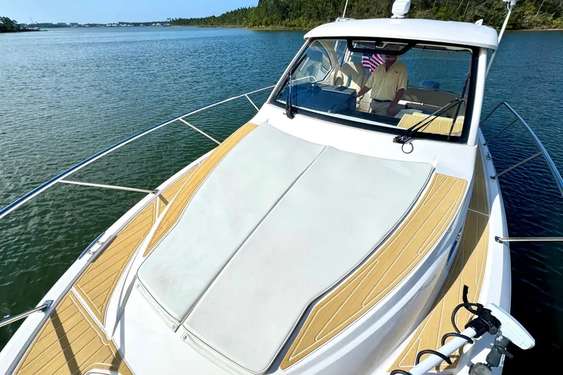 Slide: The Image of 2016 Pursuit OS 325 Offshore boat on calm water, featuring sleek design and spacious deck. - 28