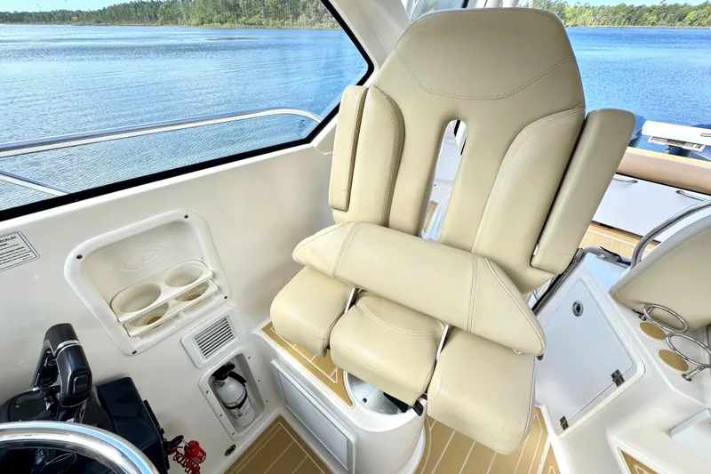 Slide: The Image of Captain's chair on 2016 Pursuit OS 325 Offshore boat, with scenic water view. - 33