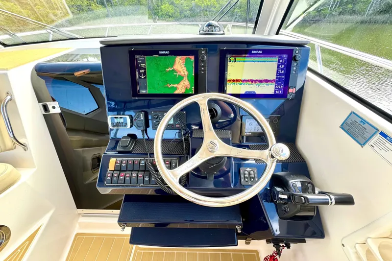 Slide: The Image of Helm of 2016 Pursuit OS 325 Offshore boat with dual Simrad displays and controls. - 35