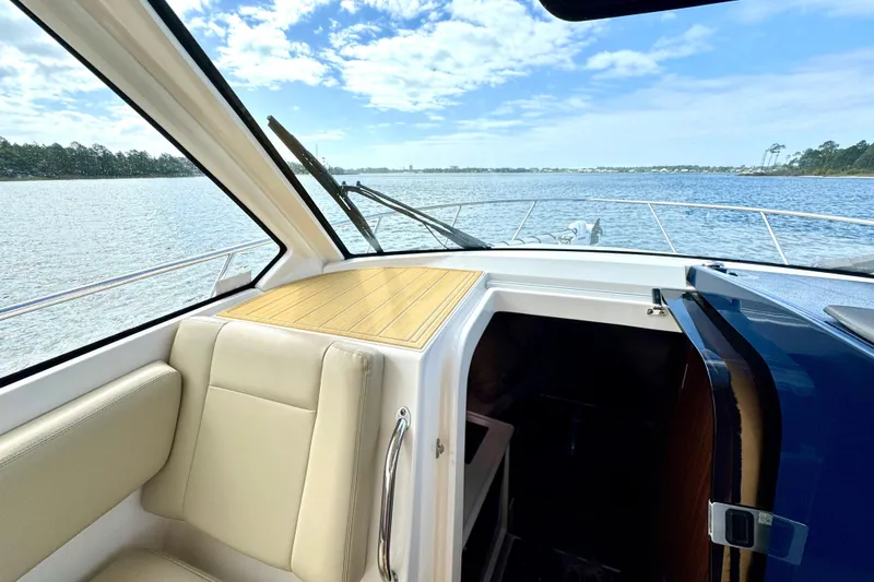 Slide: The Image of 2016 Pursuit OS 325 Offshore boat interior with scenic water view. - 38