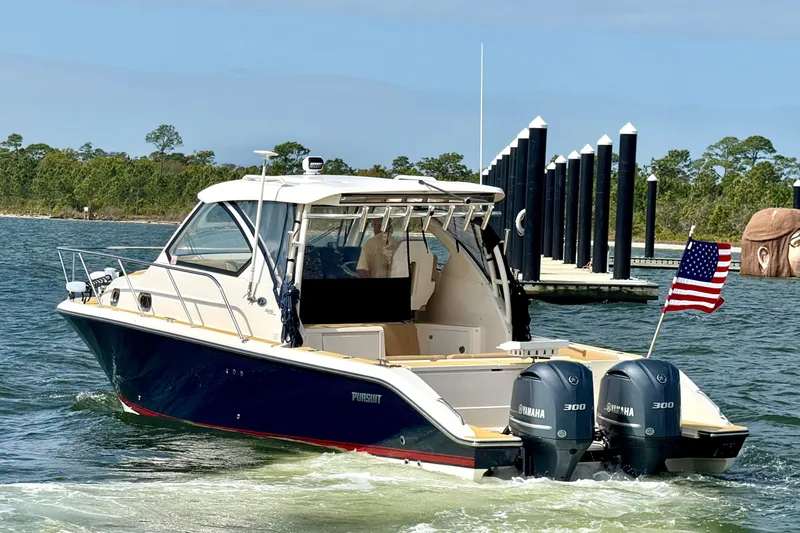 Slide: The Image of 2016 Pursuit OS 325 Offshore boat with dual Yamaha engines on the water. - 4