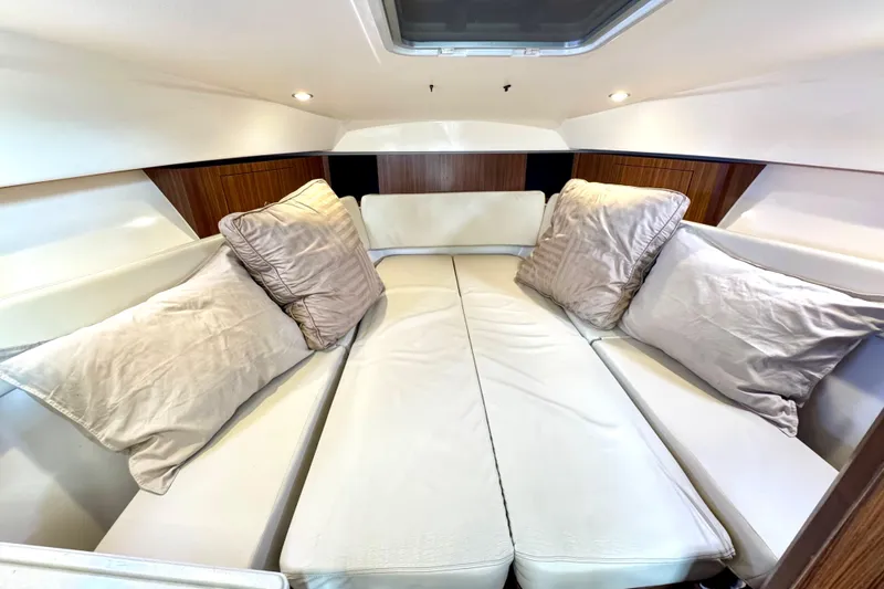 Slide: The Image of Luxurious cabin interior of 2016 Pursuit OS 325 Offshore boat with plush cushions. - 45