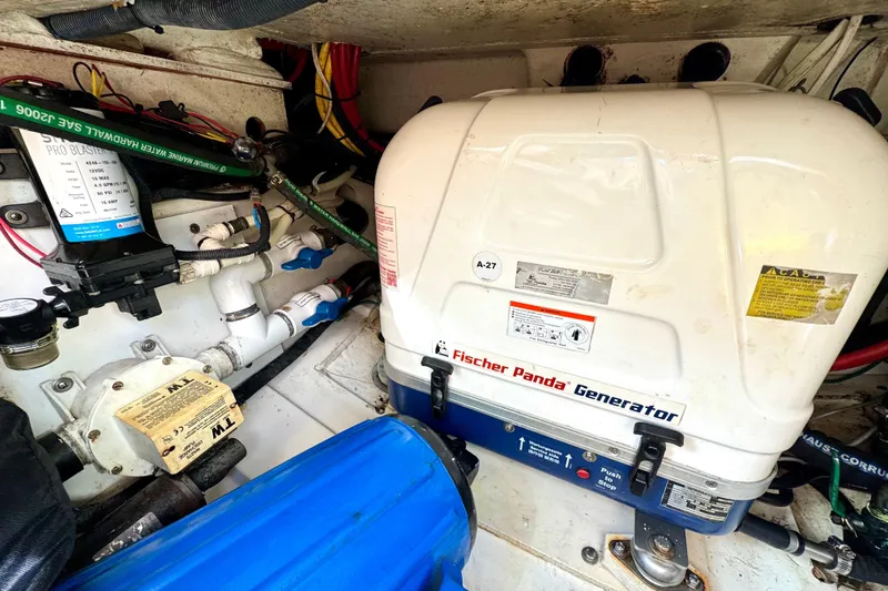 Slide: The Image of Engine room of 2016 Pursuit OS 325 Offshore with Fischer Panda generator. - 47