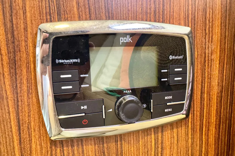 Slide: The Image of Polk audio system on 2016 Pursuit OS 325 Offshore boat, featuring SiriusXM and Bluetooth connectivity. - 49