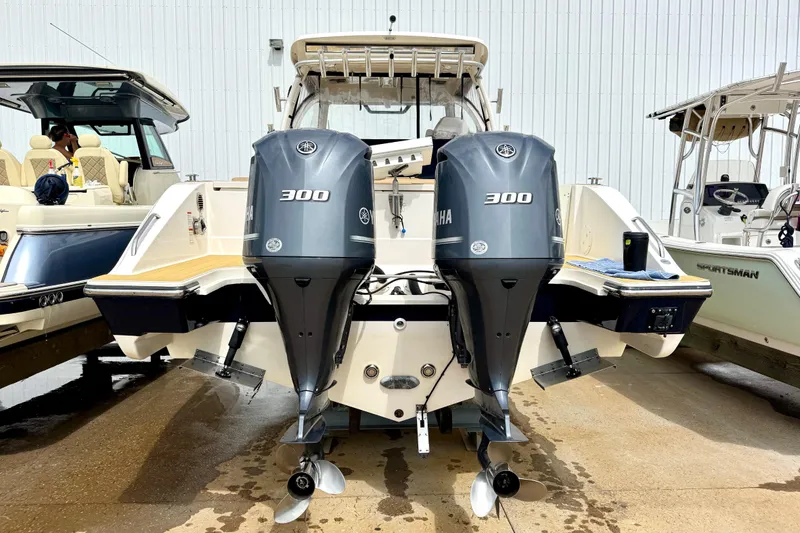 Slide: The Image of 2016 Pursuit OS 325 Offshore boat with dual Yamaha 300 engines, docked at marina. - 52