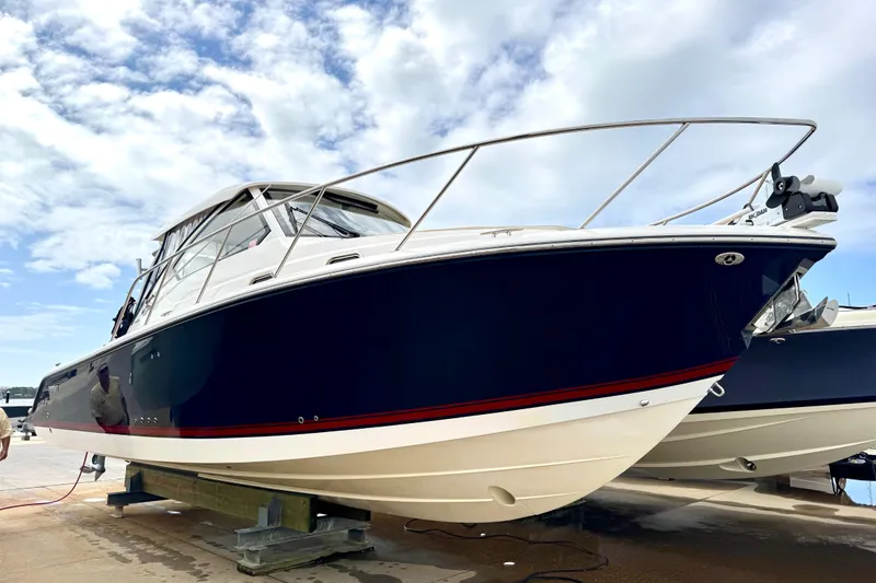 Slide: The Image of 2016 Pursuit OS 325 Offshore boat on display under a cloudy sky. - 55