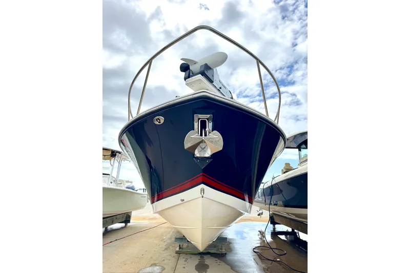 Slide: The Image of 2016 Pursuit OS 325 Offshore boat with sleek design, docked under cloudy sky. - 56