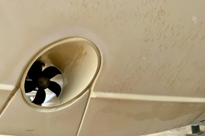 Slide: The Image of Close-up of a 2016 Pursuit OS 325 Offshore boat propeller and hull. - 58