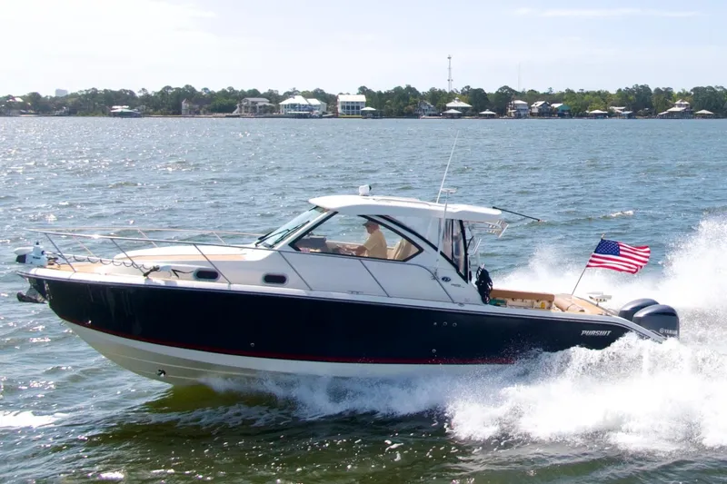 Slide: The Image of 2016 Pursuit OS 325 Offshore boat cruising on water with American flag. - 6