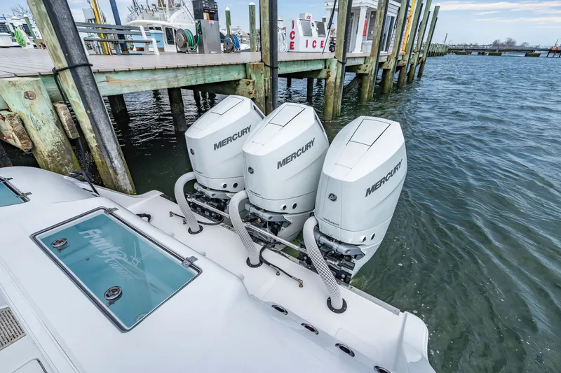 Slide: The Image of Front Runner 39 Center Console 2026 with three Mercury engines at dock. - 27