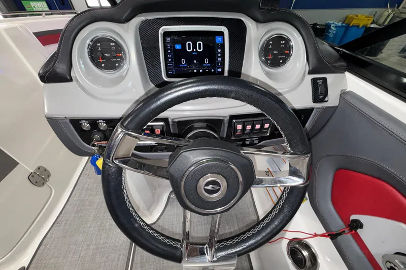 Slide: The Image of 2019 Chaparral Vortex 2430 VRX Wake Series dashboard with steering wheel and digital display. - 15