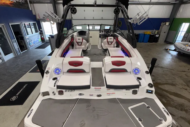 Slide: The Image of 2019 Chaparral Vortex 2430 VRX Wake Series boat interior in showroom, featuring sleek seating and modern design. - 6