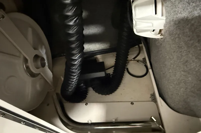 Slide: The Image of 2019 Chaparral Vortex 2430 VRX Wake Series interior compartment with hoses and equipment. - 8