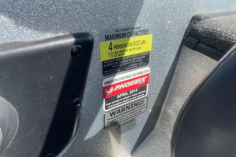 Slide: The Image of US Coast Guard capacity label on 2013 Phoenix 618 Pro boat. - 10