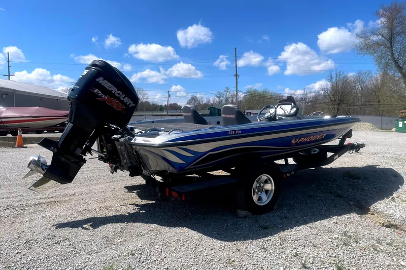 Slide: The Image of 2013 Phoenix 618 Pro boat with Mercury engine on gravel lot under blue sky. - 3